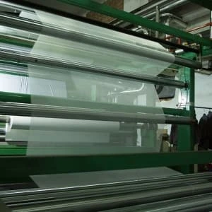 White material and metal rollers on PVC banner roll production equipment