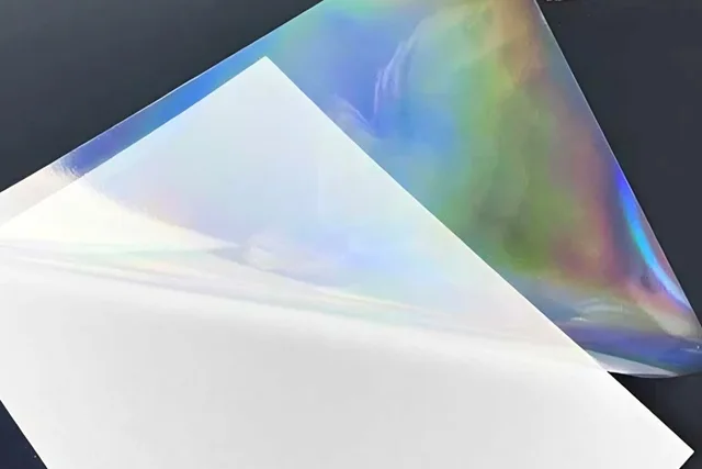 Printable holographic adhesive film with a rainbow surface effect