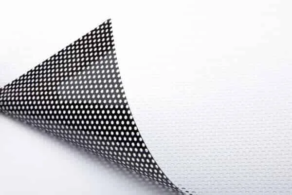 Perforated window graphics film showing its white print face and black reverse